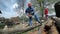 Man in protective clothes sawing timber