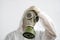 Man in protective clothing and a gasmask on a white background. a tired worker in protective suit. fatigue, head pain