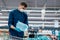 man in a protective mask buying water in a supermarket