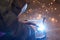 A man in a protective mask carries out welding work