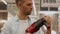 Man in a protective mask chooses a electric drill at an tools store