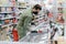 A man in a protective mask selects products in a supermarket