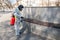 man in a protective suit disinfects benches in a public place