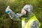 A man in a protective suit and mask against bacteria and viruses performs a test in a flask