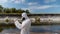 Man in a protective suit and respirator observes a chemical reaction of water in test tube