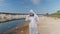 Man in a protective suit and respirator observes a chemical reaction of water in test tube