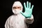 A man in a protective suit says stop the virus
