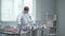 Man in protective workwear,glasses and medical gloves check tubes in the laboratory