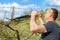 Man pruning fruit tree with clippers at springtime