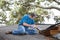 Man Prying Rotten Wood from Roof Beams and Decking