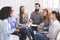 Man psychiatrist talking with patients at rehab group meeting