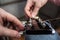 Man pulls new guitar strings acoustic guitar in closeup