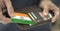 Man pulls plastic bank card with flag of India out of his wallet, fictional card number