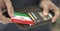 Man pulls plastic card with flag of Iran out of his wallet, fictional card number