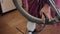 A man pumps air into a bicycle wheel with a foot pump. Close-up shot