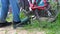 A man pumps a bicycle wheel with a mechanical foot pump in front of a bike ride