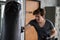 man punch boxing sandbag in fitness gym