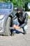 Man punctures a car tyre.