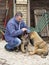 Man with puppies breed Tibetan Mastiff