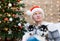 Man and puppy husky, Santa Claus hat, close up