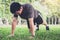 Man push-up exercise workout fitness doing outside on grass in