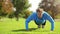 Man, push up and fitness face in a park for workout, exercise and strength training on field grass. Sport, athlete and