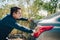 Man pushing a broken car breakdown on the road hot day. Car broken concept