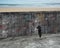 Man pushing huge puzzle door of business doodles concrete wall