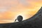 Man pushing large stone to the top