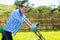 Man pushing lawnmower