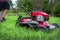 Man pushing lawnmower cutting grass in residential backyard