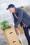 Man pushing stack moving boxes on hand truck