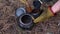 Man puts coffee in a kettle on a campsite. Bushcraft, close-up