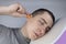 The man puts on earplugs. Close-up of an orange noise barrier. Deep sleep. The ENT doctor advises orange earmuffs to reduce