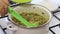 A man puts freshly made sorrel soup into a bowl. Regional food. Close-up shot