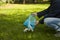 A man puts garbage in a bag in a Park