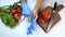 Man puts on gloves on arms by table where vegetables lie in kitchen.