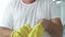 Man Puts His Yellow Protective Gloves on His Hands Preparing to Start Cleaning in the Kitchen and Bathroom