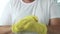 Man Puts His Yellow Protective Gloves on His Hands Preparing to Start Cleaning in the Kitchen and Bathroom