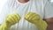Man Puts His Yellow Protective Gloves on His Hands Preparing to Start Cleaning in the Kitchen and Bathroom