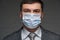 A man puts a mask on his face for antivirus individual protection - healthcare and medicine concept, prevention tips