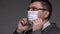A man puts a mask on his face for antivirus individual protection - healthcare and medicine concept, prevention tips