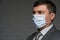 A man puts a mask on his face for antivirus individual protection - healthcare and medicine concept, prevention tips