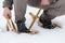 A man puts on snowshoes, rural vintage snowshoes