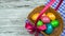 Man puts on a table the Easter basket with Decorated and colored eggs, concept of Christian holiday Pascha or