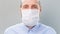 Man puts on and take off a gauze antivirus mask
