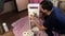 A man puts toilet paper on a homemade shelf. Making furniture at home