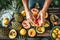 A man puts various grilled fruits on a dish. May holidays concept of vegetarian fruit barbecue, party, summer holidays