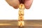 A man puts wooden cubes on the table with the inscription - FLSA