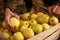 Man puts yellow ripe golden apple to a wooden box of yellow at the orchard farm. Grower harvesting in the garden and holding organ